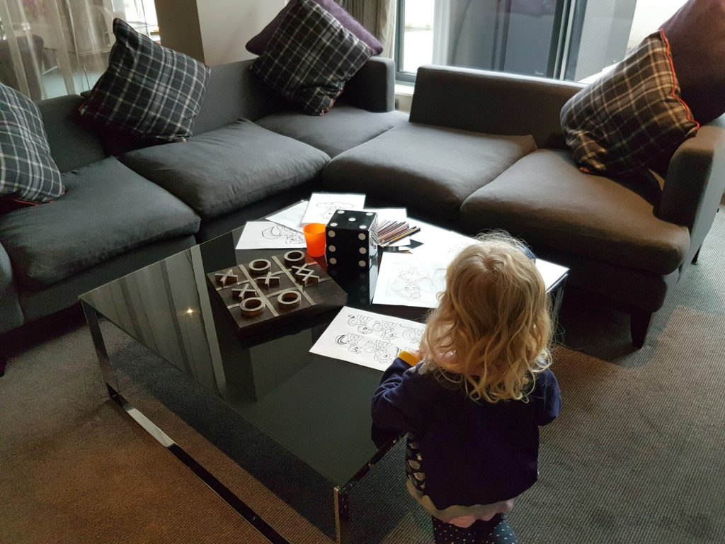 A girl doing colouring in the living area of our suite at Brooklands Hotel, Surrey - my review of our stay at Brooklands Hotel with kids