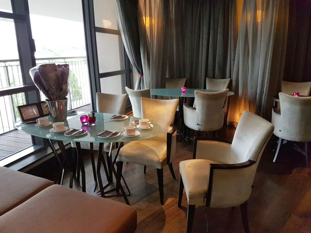 Tables and velvet chairs in the waiting area of the spa at Brooklands Hotel, Surrey - my review of our stay at Brooklands Hotel with kids