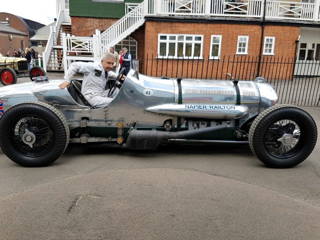 The driver climbs out of the shiny silver metal Napier Railton classic race car - my review of Brooklands Museum in Surrey after our family day out