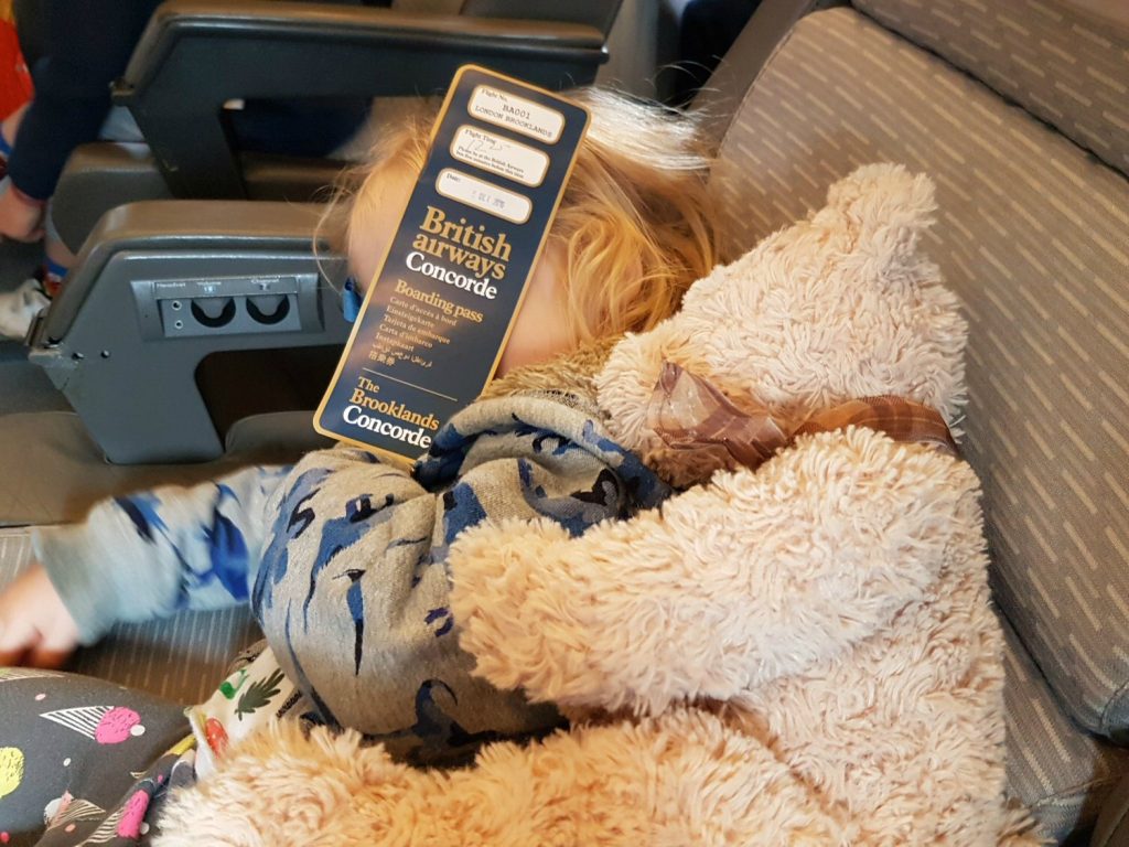 Girl plus teddy bear relax on board Concorde - my review of Brooklands Museum in Surrey after our family day out