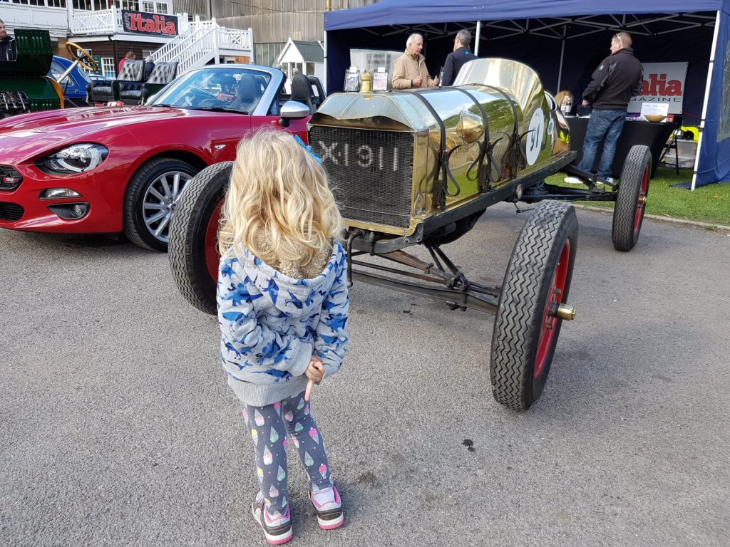 Girl looking at vintage cars on display - my review of Brooklands Museum in Surrey after our family day out