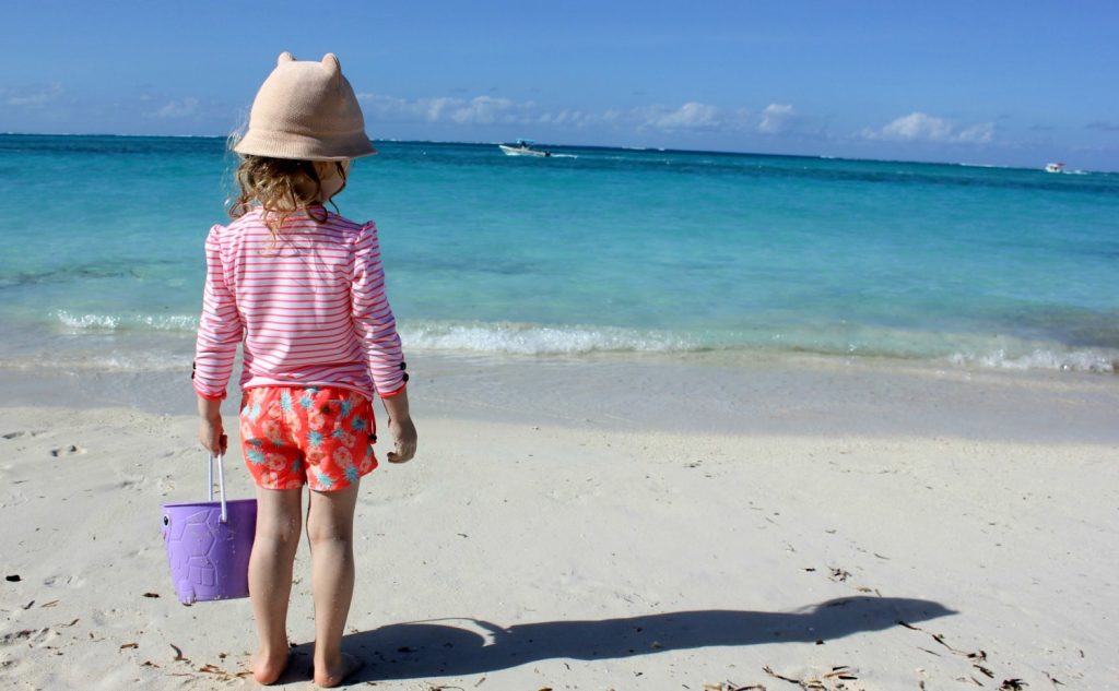 A girl looks out to the turquoise waters of the Caribbean - my top 9 reasons to visit Beaches Turks & Caicos with kids
