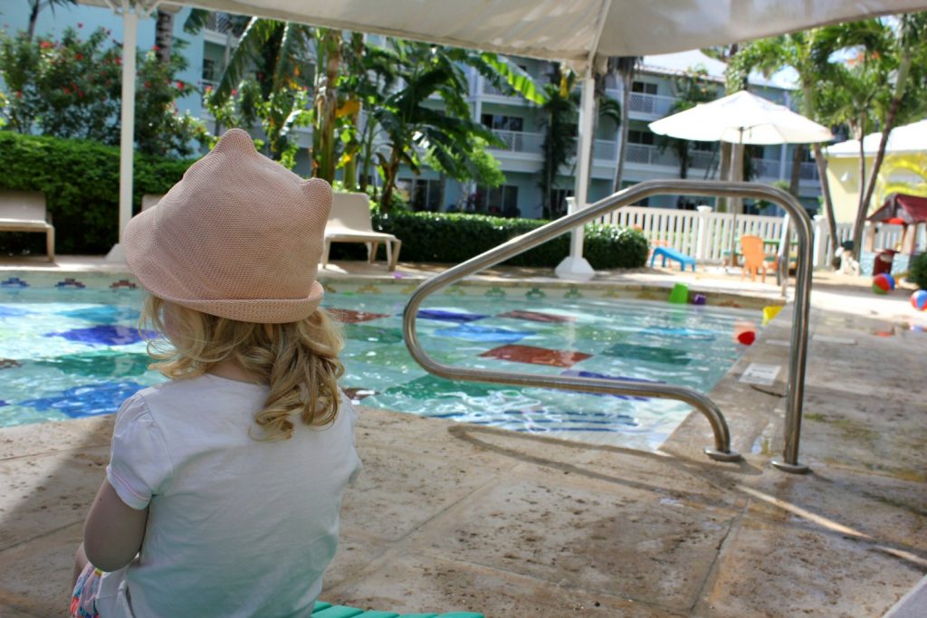 A girl sits by the small kids' club pool - one of my 9 top reasons to visit Beaches Turks & Caicos with kids