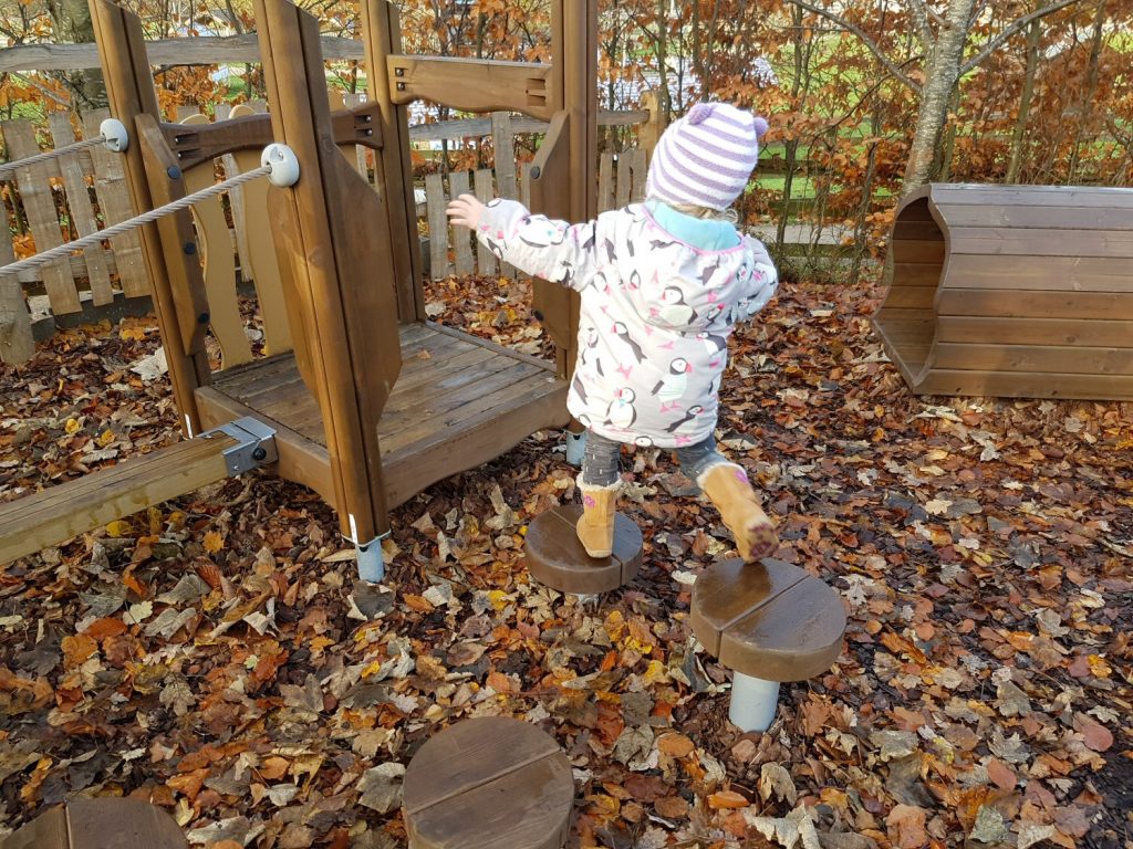My daughter clambers arond the Peter Rabbit adventure playground at Willows Activity Farm Santa Spectacular near St Albans in Hertfordshire - my review of our family day out