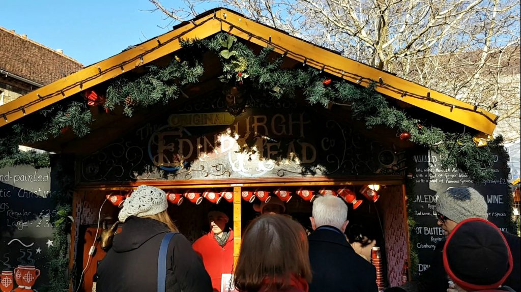 One of the food stalls with greenery on the wooden roof - our visit to Winchester Christmas market with kids