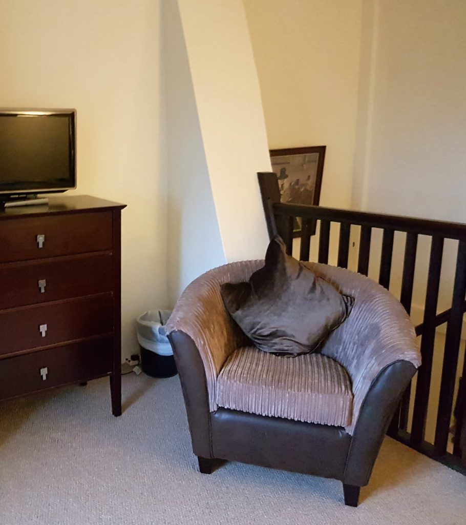 A comfy chair in the bedroom at Clydey Cottages Pembrokeshire in Wales - my Clydey Cottages review, after our stay at this family-friendly holiday cottage