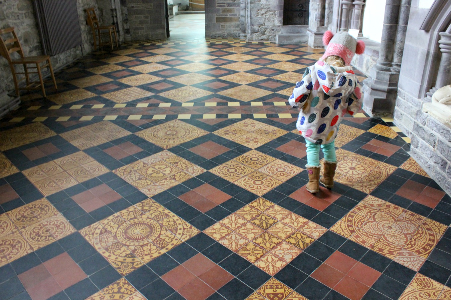 Girl on the ornate tiled floor of St David's Cathedral - on our journey to discover Welsh legends