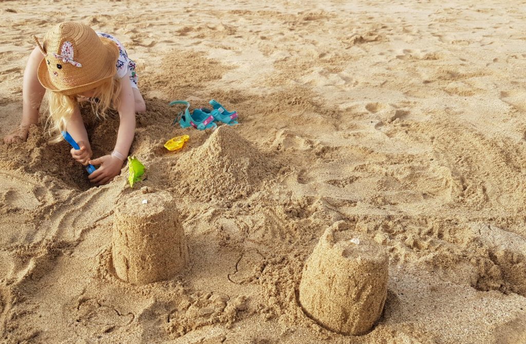 My daughter making sandcastles on the beach in Sal, Cape Verde. So should you visit Cape Verde with kids? My top tips on exploring these family-friendly islands off Africa