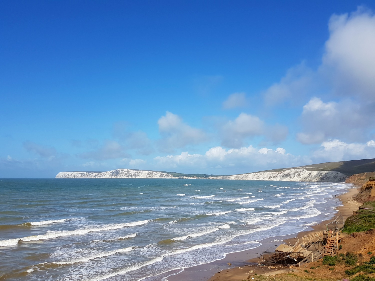A view along the Isle of Wight coast in the south of the island, looking across the waves to the white cliffs