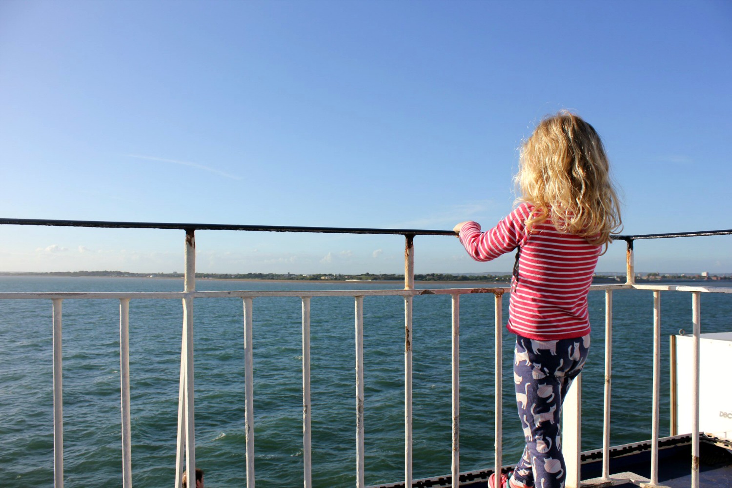 My daughter on the ferry from the Isle of Wight coast back to Portsmouth - my guide to the Isle of Wight with kids