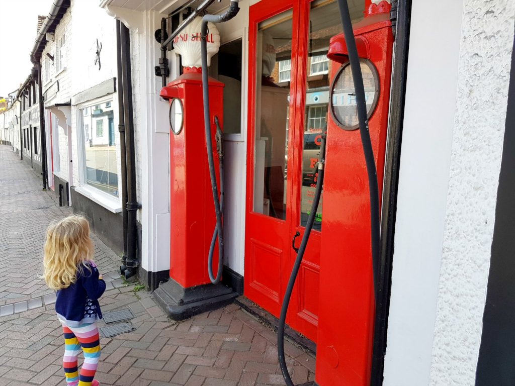 A girl looks at the vintage petrol pumps in Great Missenden which inspired Roald Dahl - my Roald Dahl Museum review