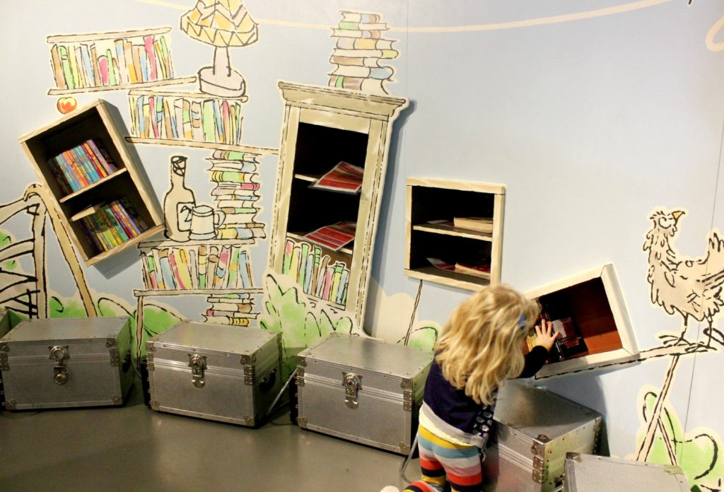A girl investigates the books dotted around the museum - my Roald Dahl Museum review