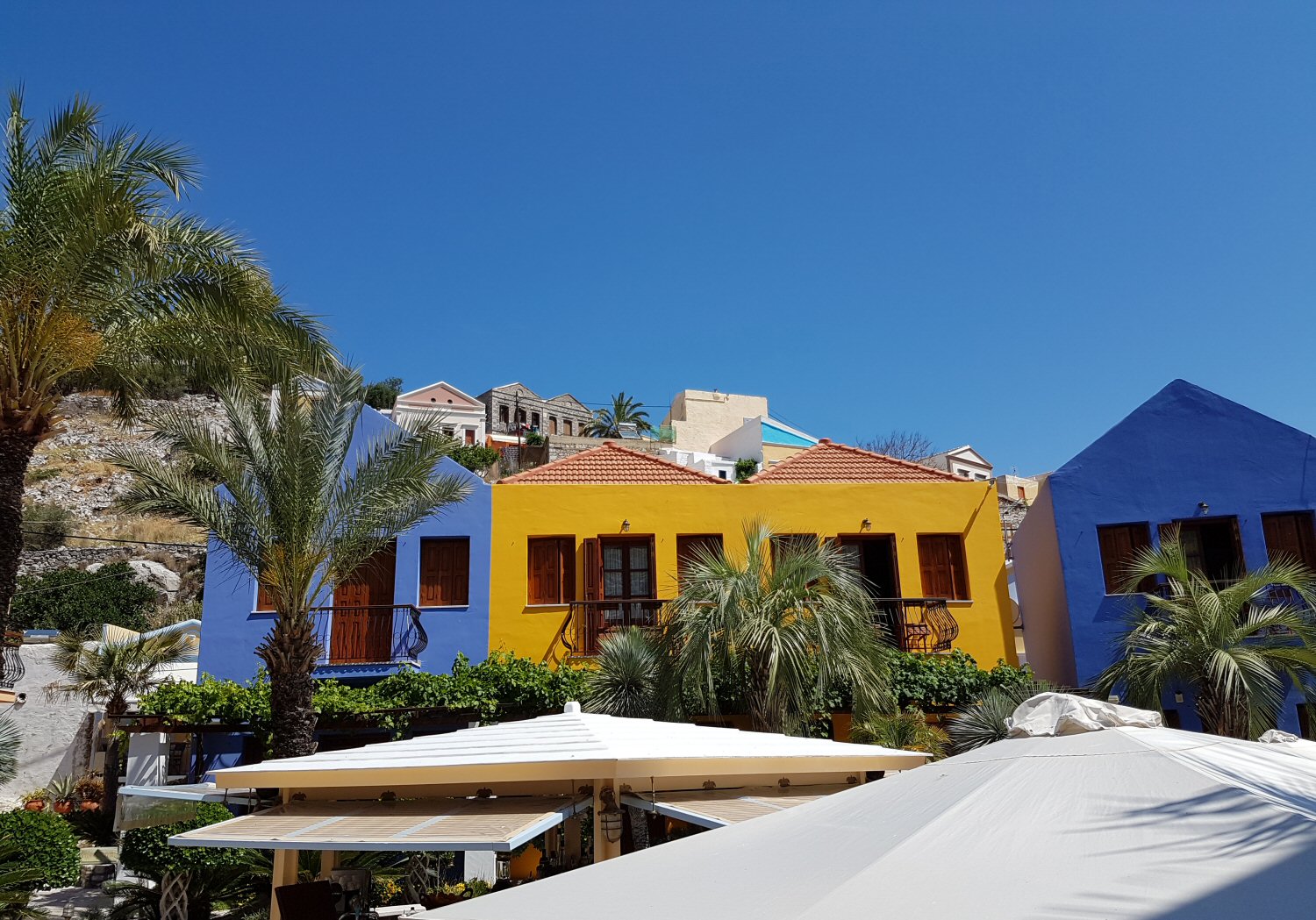 The bright colours of the buildings at Iapetos Village on Symi in Greece - my Iapetos Village Symi review