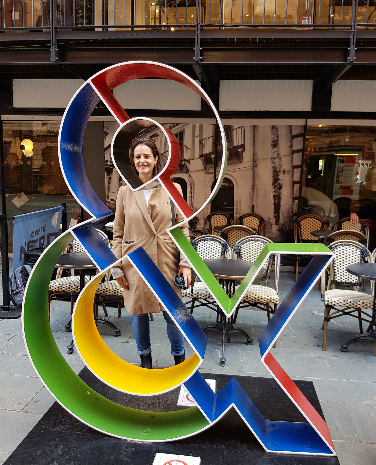 Maria from One Tiny Leap blog stands by a colourful ampersand sculpture - my London Instawalk along the South Bank