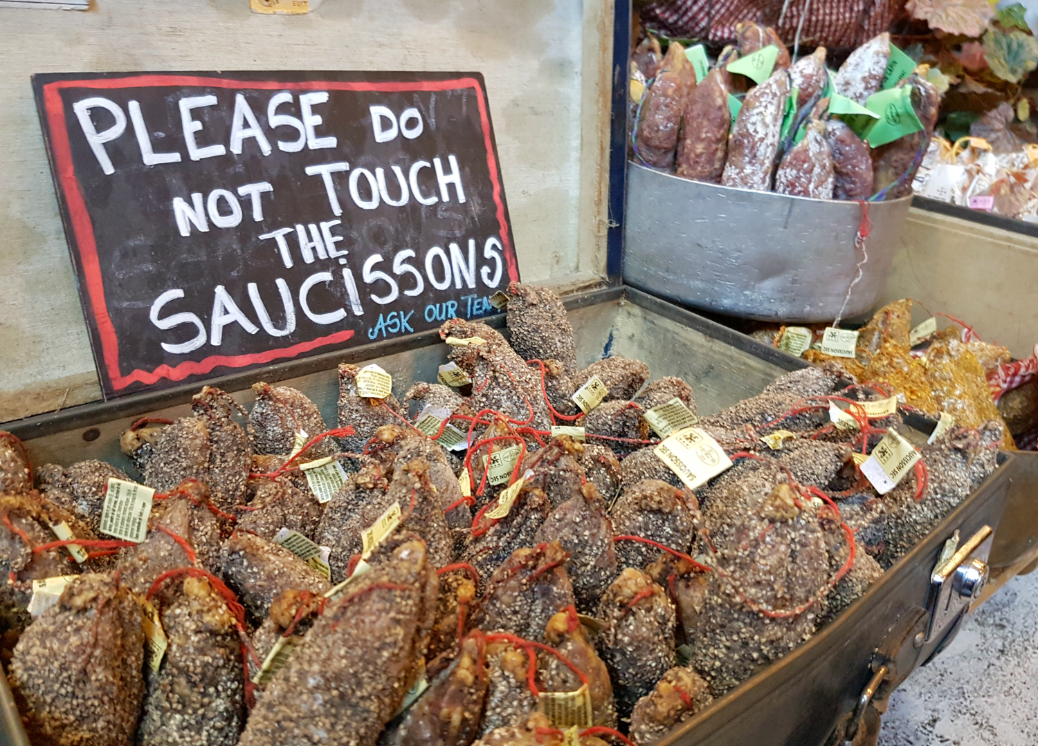 Don't touch the saucissons sign above food at Borough Market - my London Instawalk along the South Bank