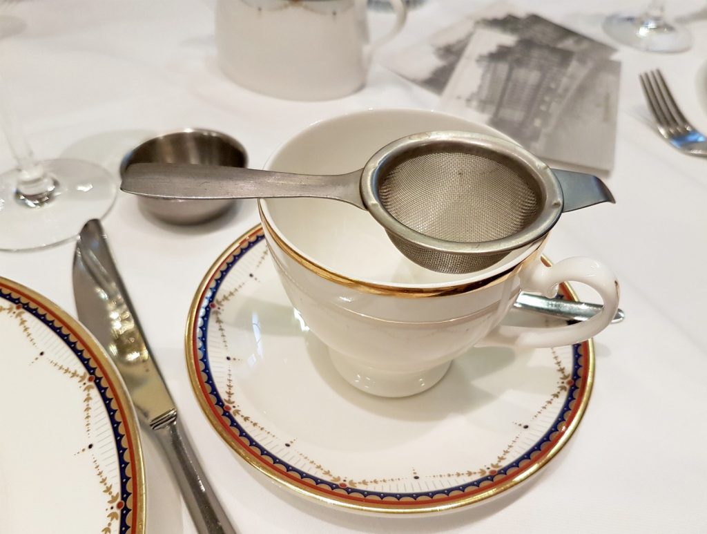 Tea strainer balanced on a china cup - my review of Waldorf Hilton afternoon tea
