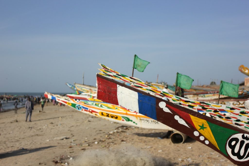 The brightly painted prow of boats on the sand at Tanji - nine reasons to visit The Gambia, in photos