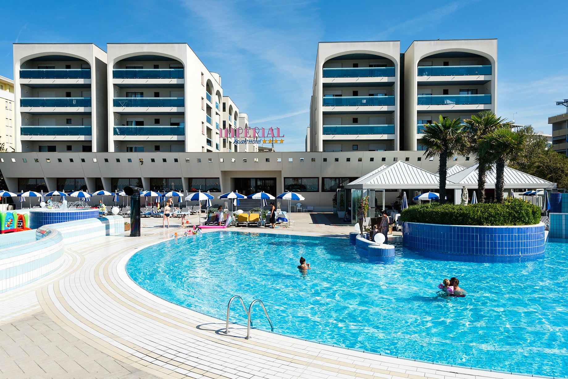 A view of the pool with Imperial Aparthotel in Bibione behind it why it's worth considering Bibione with kids if you visit Italy's Veneto region