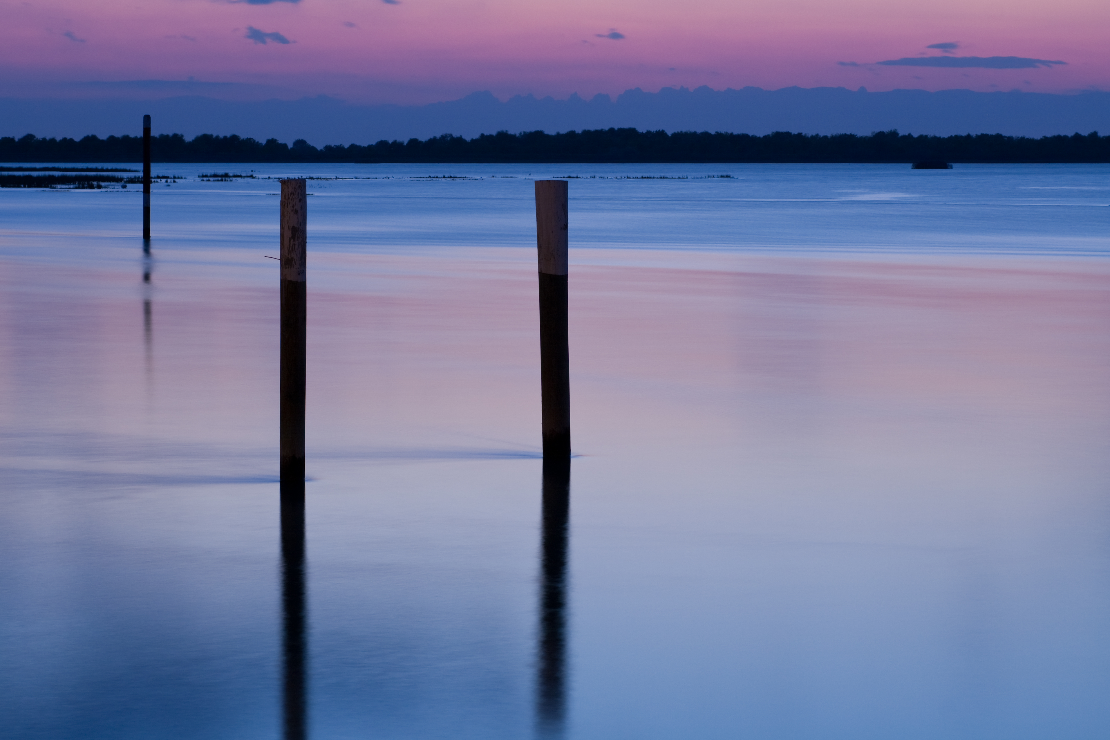 A view of the lagoon in the twilight against purpley pink clouds why it's worth considering Bibione with kids if you visit Italy's Veneto region