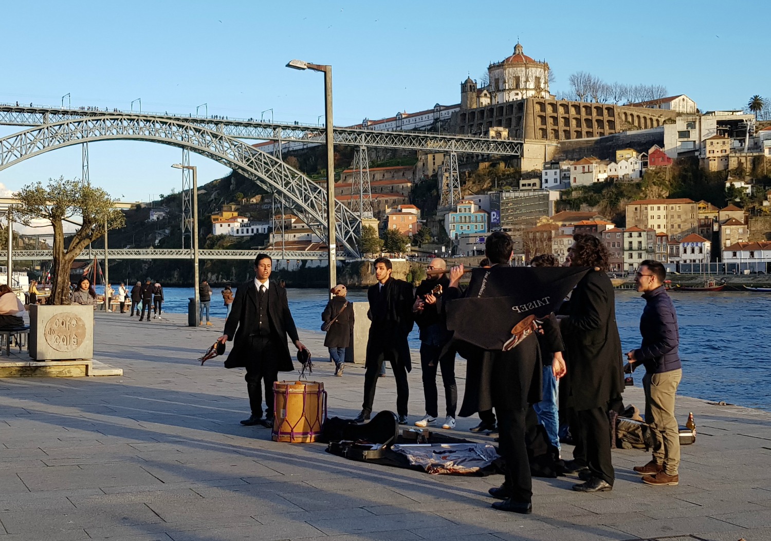 Street entertainers singing by the river in Porto - exploring the riverfront is one of the best things to do in Porto for families