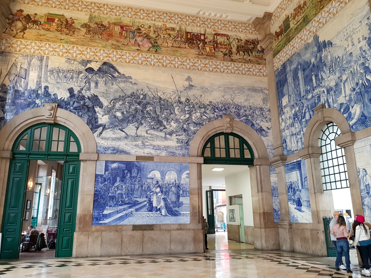 Intricate hand-painted tiles in Sao Bento train station in Porto - a visit is one of the unmissable things to do in Porto with kdis