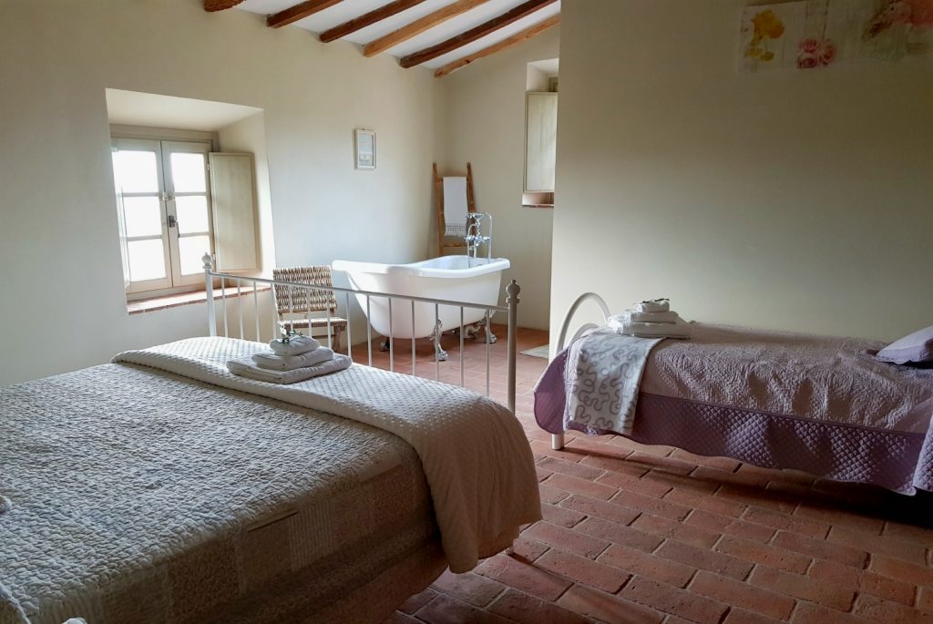 Rolltop bath and beds in another bedroom at Villa Le Capanne near Volterra in Tuscany - my review of the perfect big family villa in Tuscany, Italy