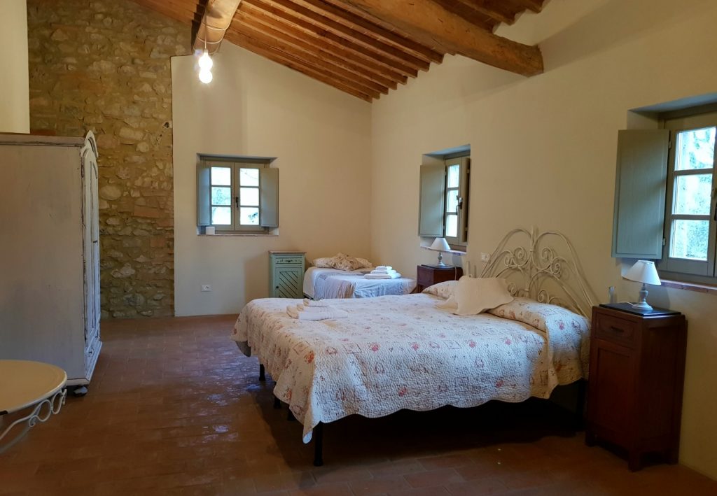 Bed in one of the suites at Villa Le Capanne near Volterra in Tuscany - my review of the perfect big family villa in Tuscany, Italy