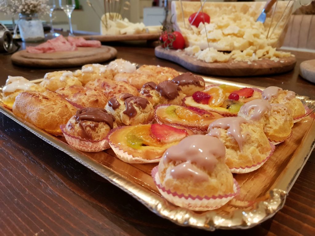 Tray of cakes and other pre-dinner nibbles on the table at Villa Le Capanne near Volterra in Tuscany - my review of the perfect big family villa in Tuscany, Italy