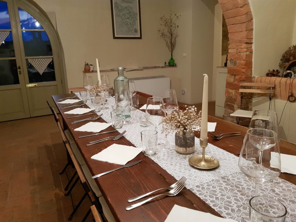 One of two dining tables, laid for dinner at Villa Le Capanne near Volterra in Tuscany - my review of the perfect big family villa in Tuscany, Italy
