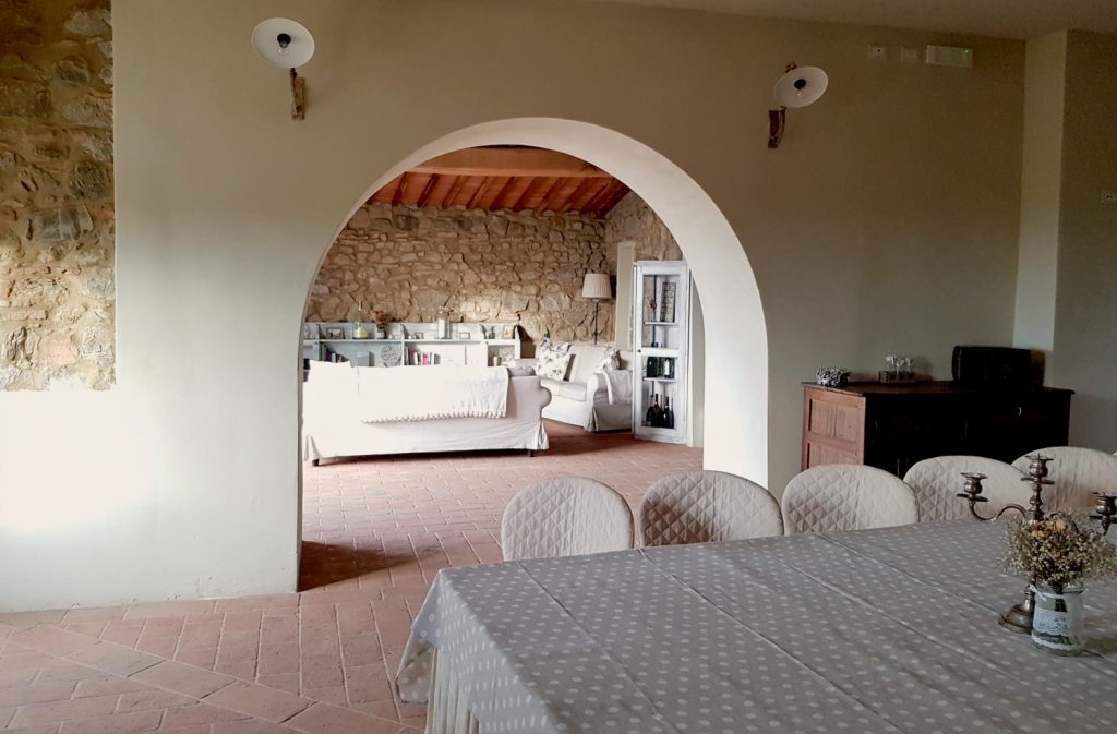 Looking from the dining room to living room through an archway at Villa Le Capanne near Volterra in Tuscany - my review of the perfect big family villa in Tuscany, Italy