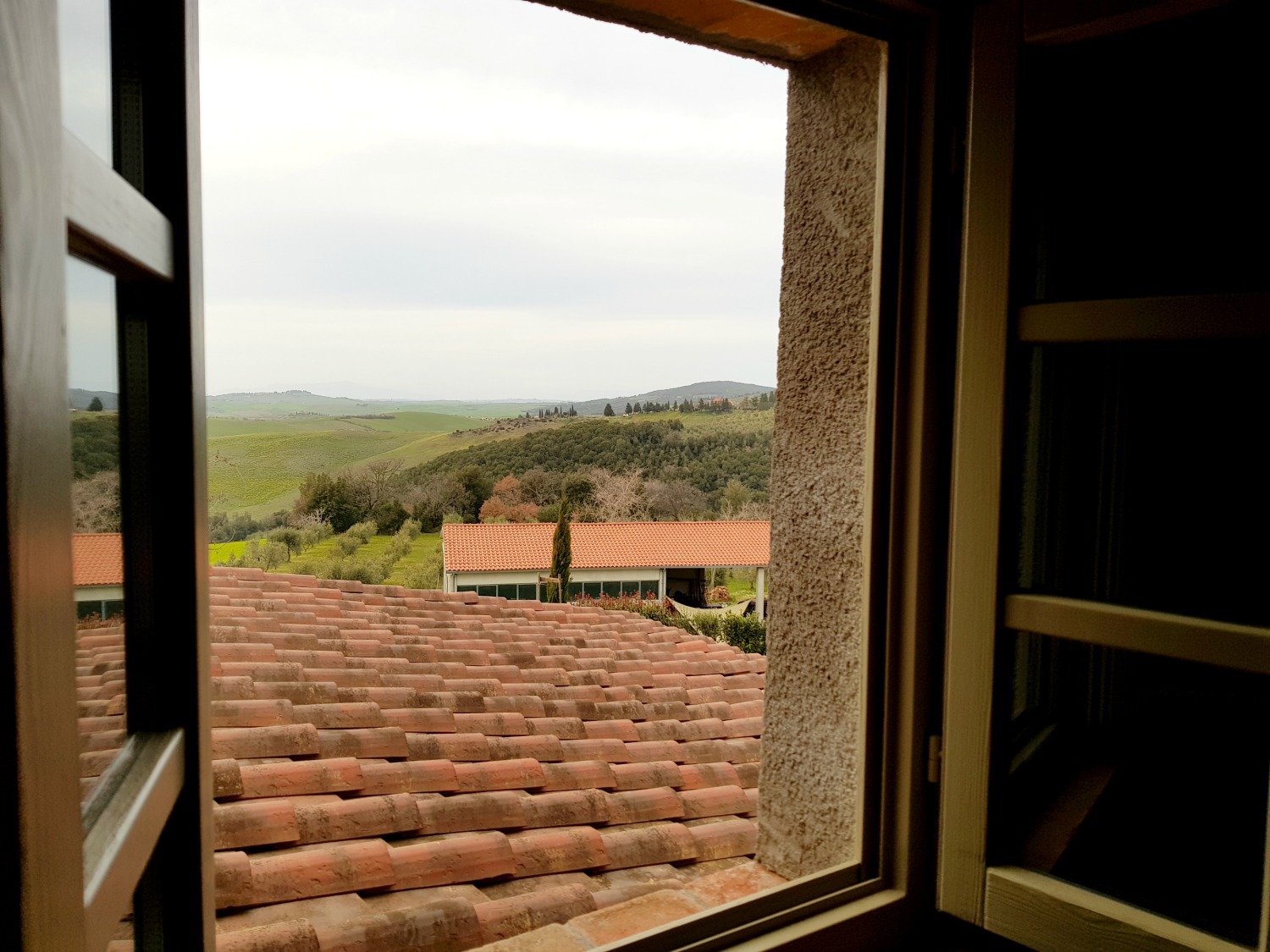 A view across the roof to the hills from one of the bedrooms at Villa Le Capanne near Volterra in Tuscany - my review of the perfect big family villa in Tuscany, Italy