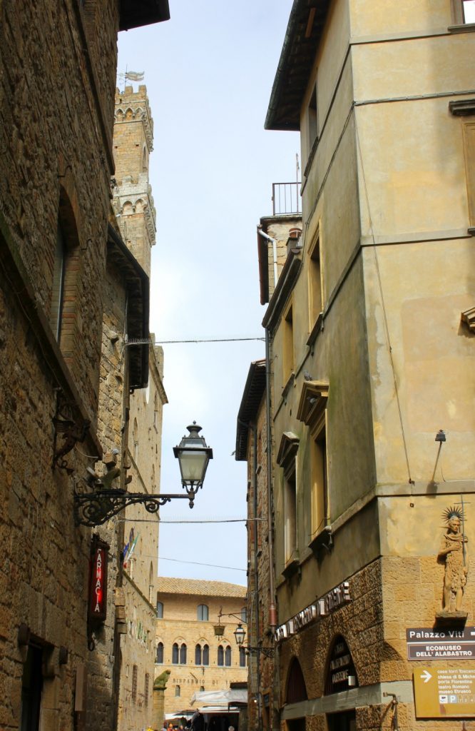 Looking up to buildings and street lamp in Volterra during my stay at Villa Le Capanne in Tuscany - my review of the perfect big family villa in Tuscany, Italy