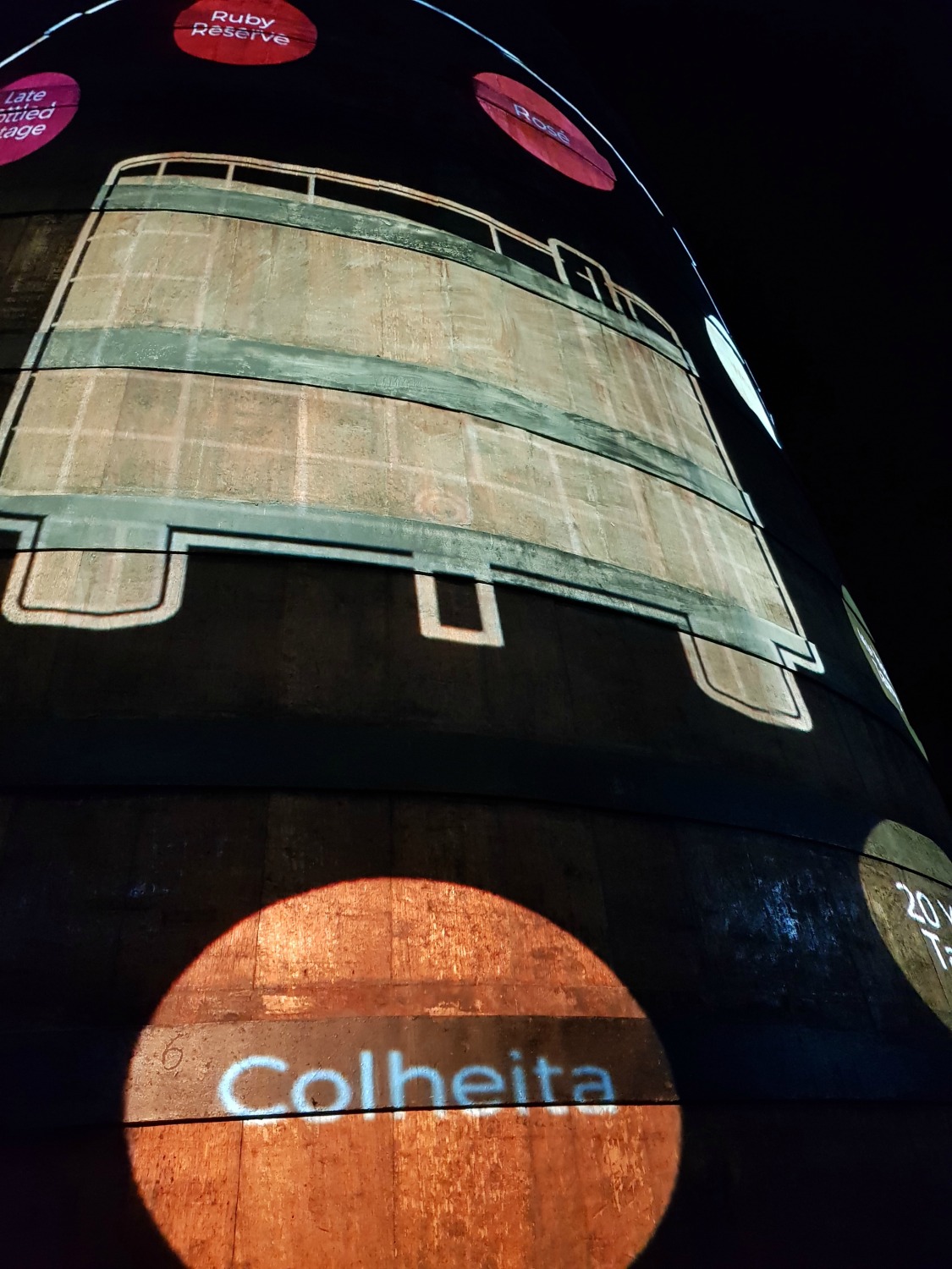 A display shone onto one of the huge port barrels as part of the tour of the cellar at Caves Calem in Vila Nova de Gaia, across the river from Porto - my Porto travel tips and lessons for visiting with kids
