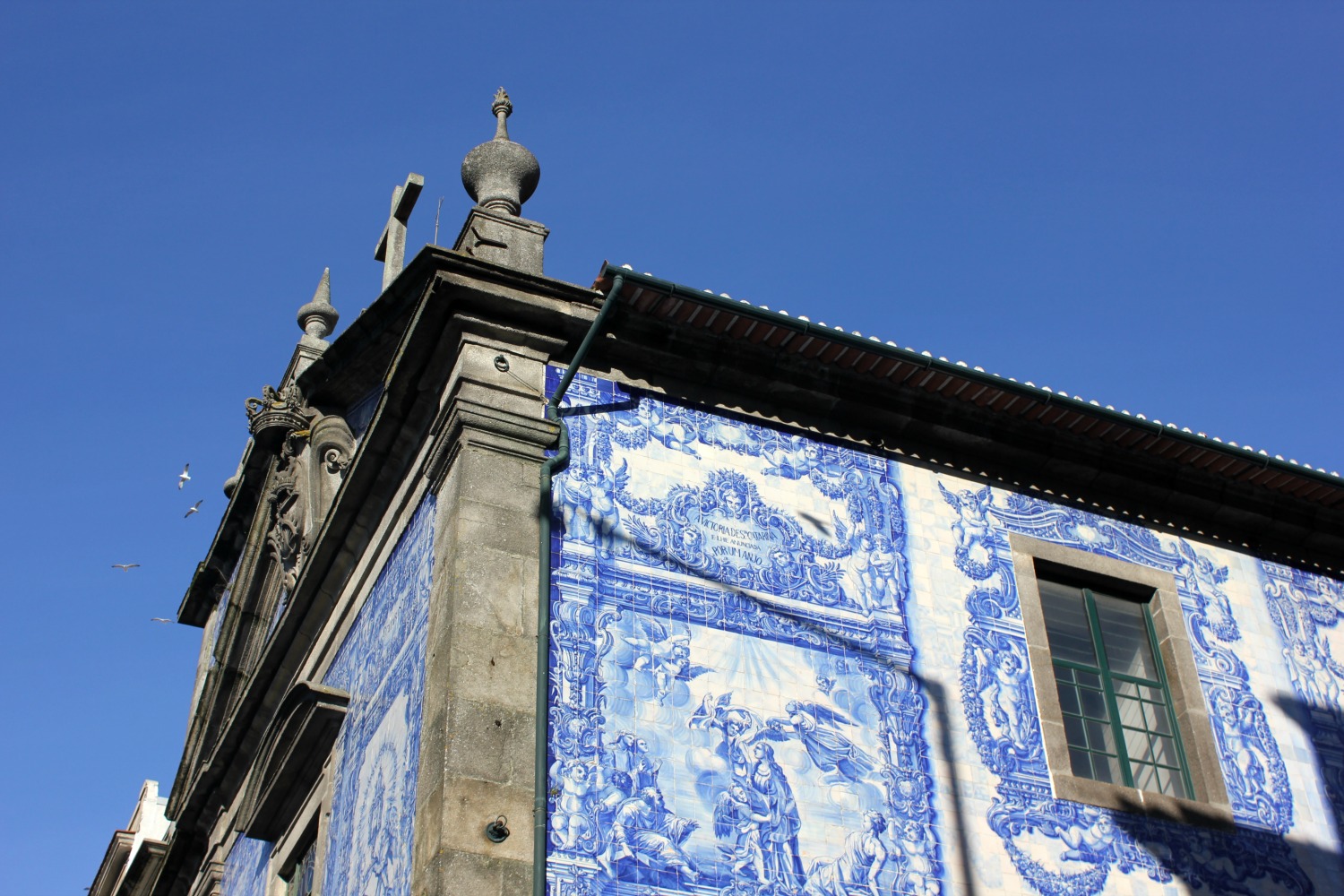 Tiled exterior of an old convent against a blue sky in Porto - my Porto travel tips and lessons for visiting with kids