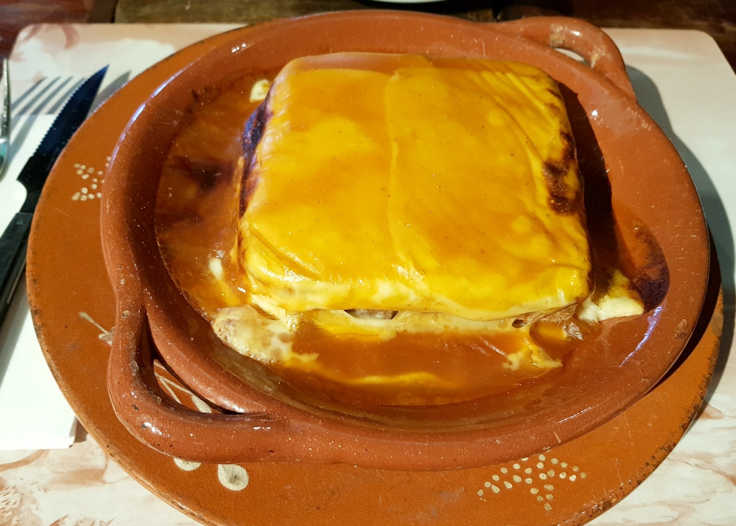 A francesinha sandwich in a restaurant in Porto, one of the city's traditional dishes - my Porto travel tips and lessons for visiting the city with kids