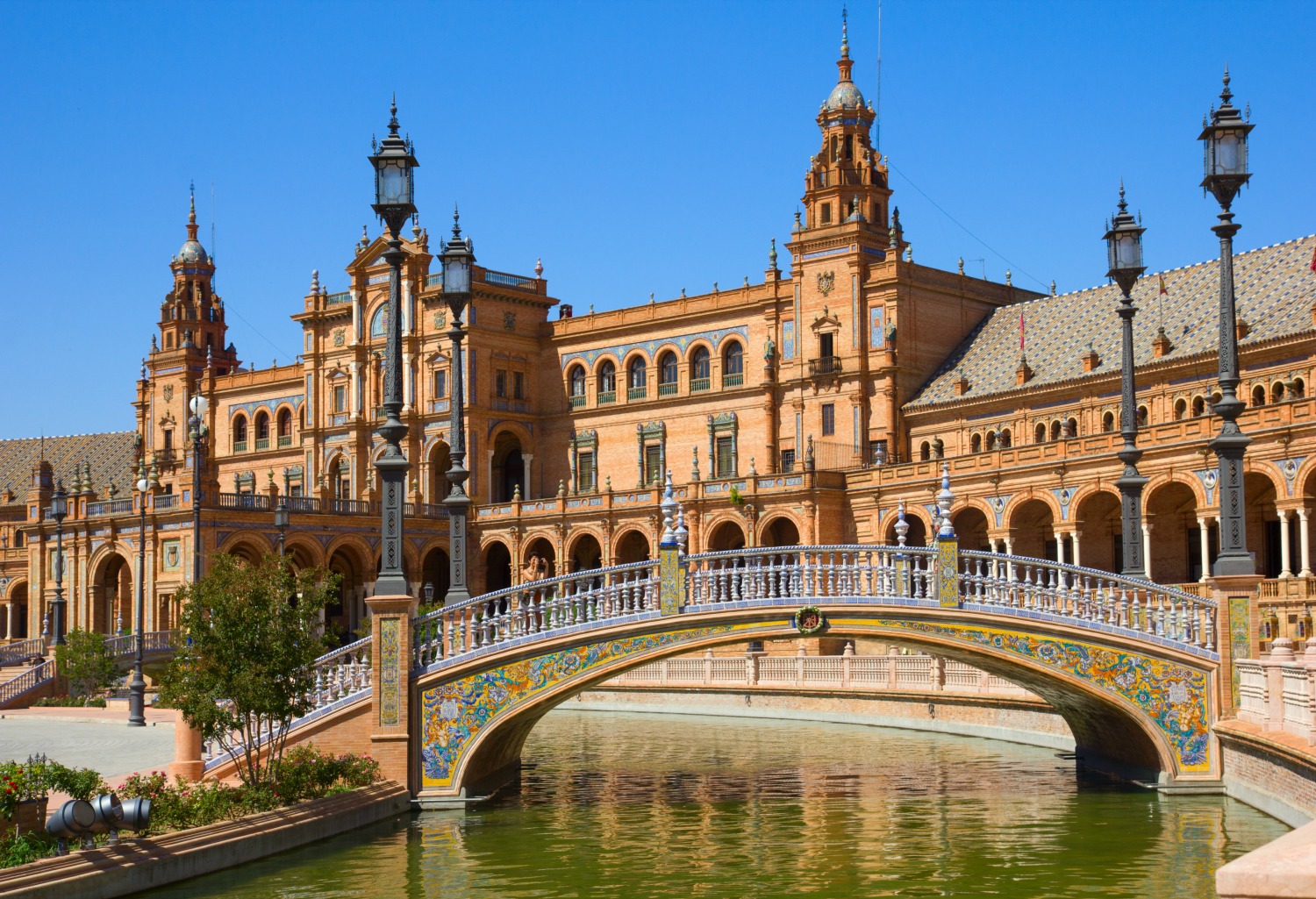 The Plaza de espana in Seville, warm golden architecture against a blue sky - one of the places on my dream holiday wishlist