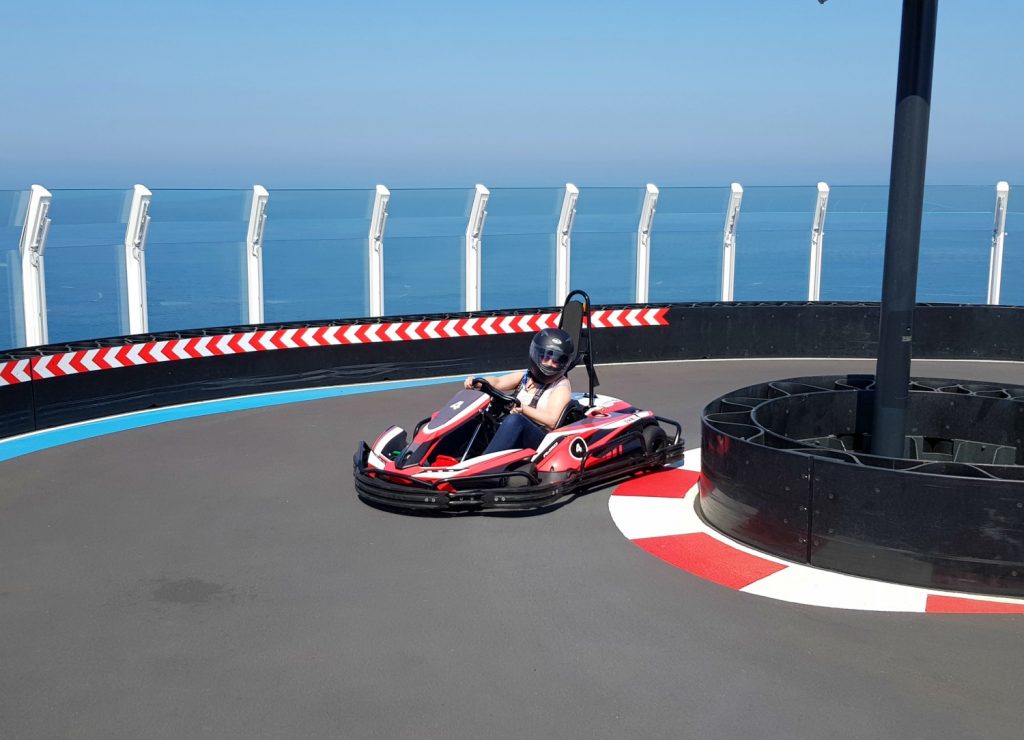 Me racing around the Norwegian Bliss race rack with the sea in the background - one of my 9 reasons families should choose Norwegian Bliss