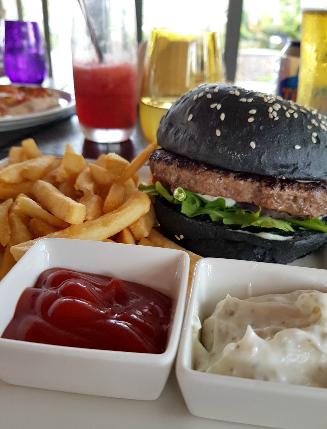 Burger in a black bun in The Terrace restaurant at The Danna Langkawi - my Danna Langkawi review if you're visiting the luxury hotel in Malaysia with kids