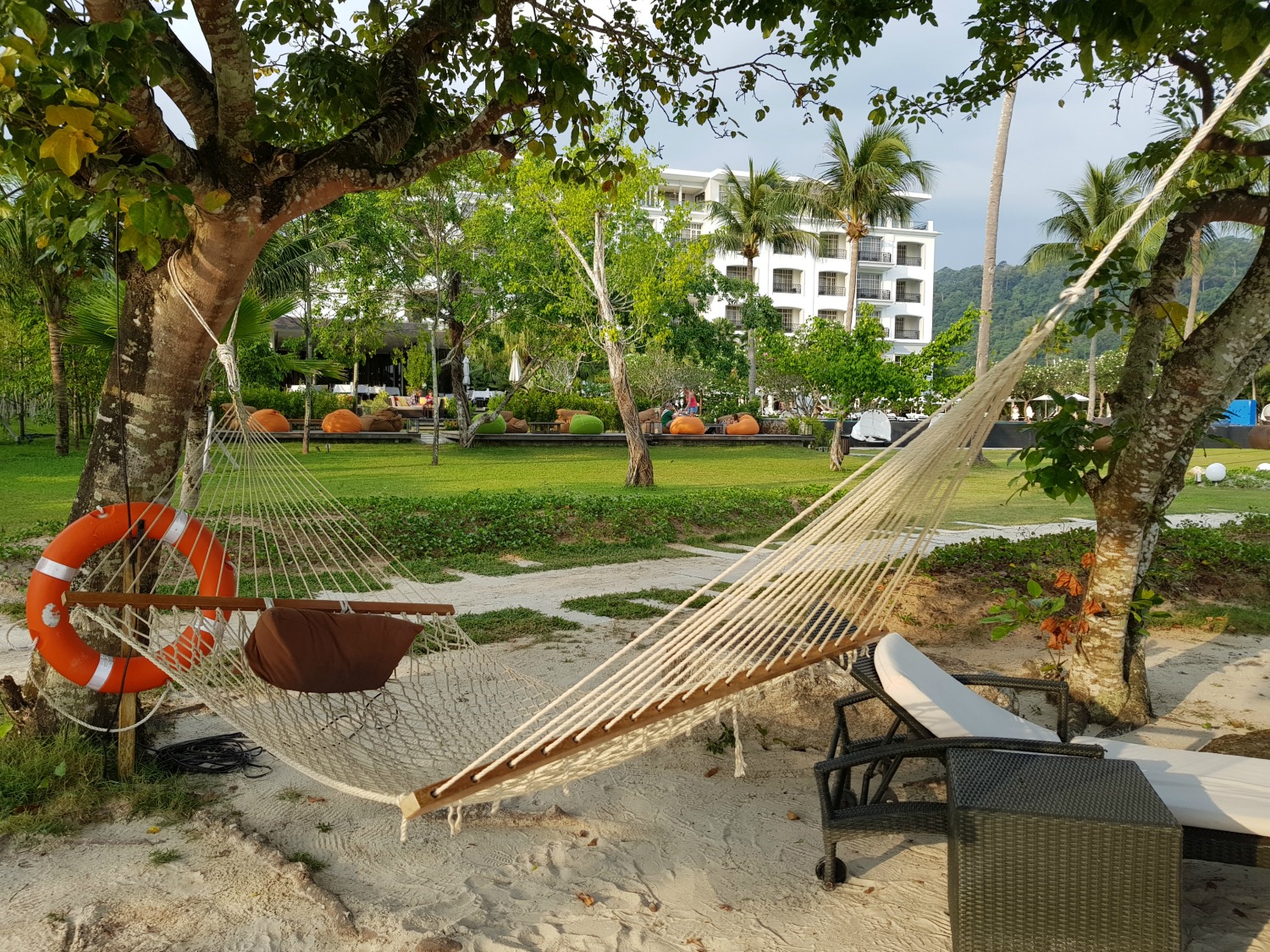 Hammock on the beach at The Danna Langkawi with the hotel in the background - my Danna Langkawi review if you're visiting the luxury hotel in Malaysia with kids