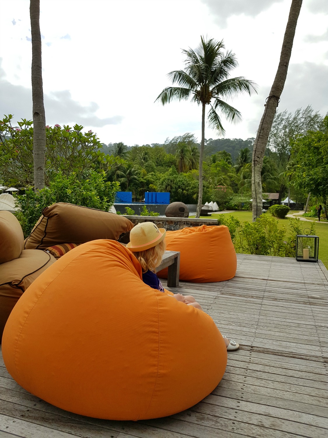 My daughter on a huge beanbag in the lounging area at The Danna Langkawi - my Danna Langkawi review if you're visiting the luxury hotel in Malaysia with kids