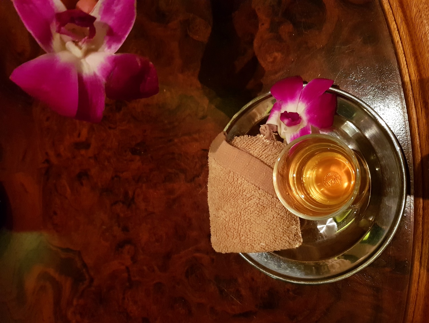 Welcome drink and cold towel decorated with flowers at The Danna Langkawi - my Danna Langkawi review if you're visiting the luxury hotel in Malaysia with kids