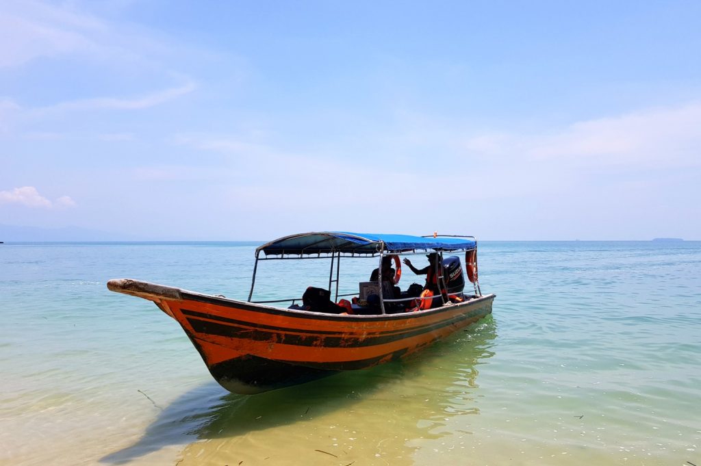 Our boat by the beach in Langkawi as part of a tour through the mangroves - my top Langkawi tour with kids
