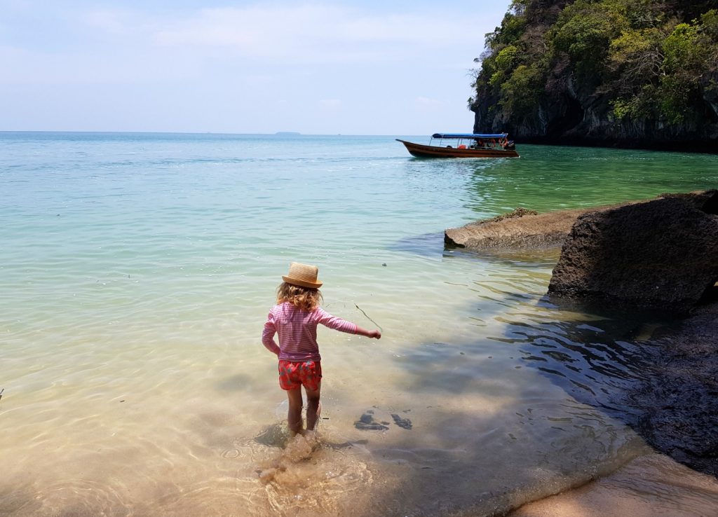 My daughter paddles by the beach in Langkawi as part of a tour through the mangroves - my top Langkawi tour with kids