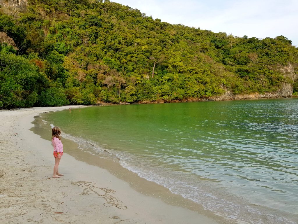 My daughter by a beach on our Langkawi sea safari - my top Langkawi tour with kids