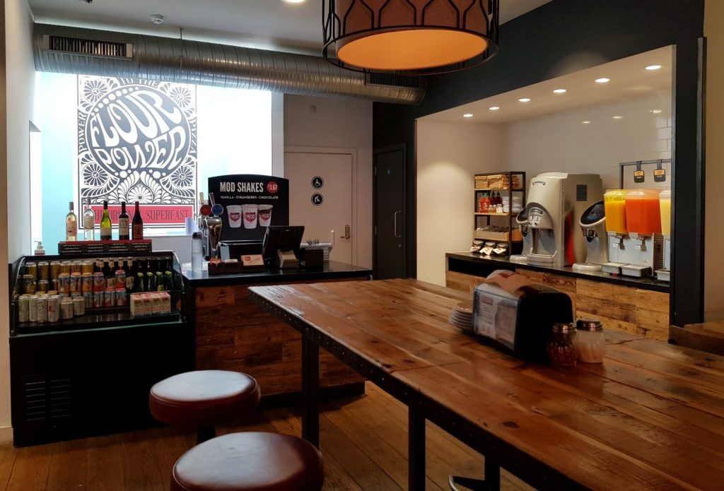 Drinks machines and tables inside MOD Pizza - the restaurant near Leicester Square has deals for Kids Week London 2018, with discounts on children's tickets for West End shows