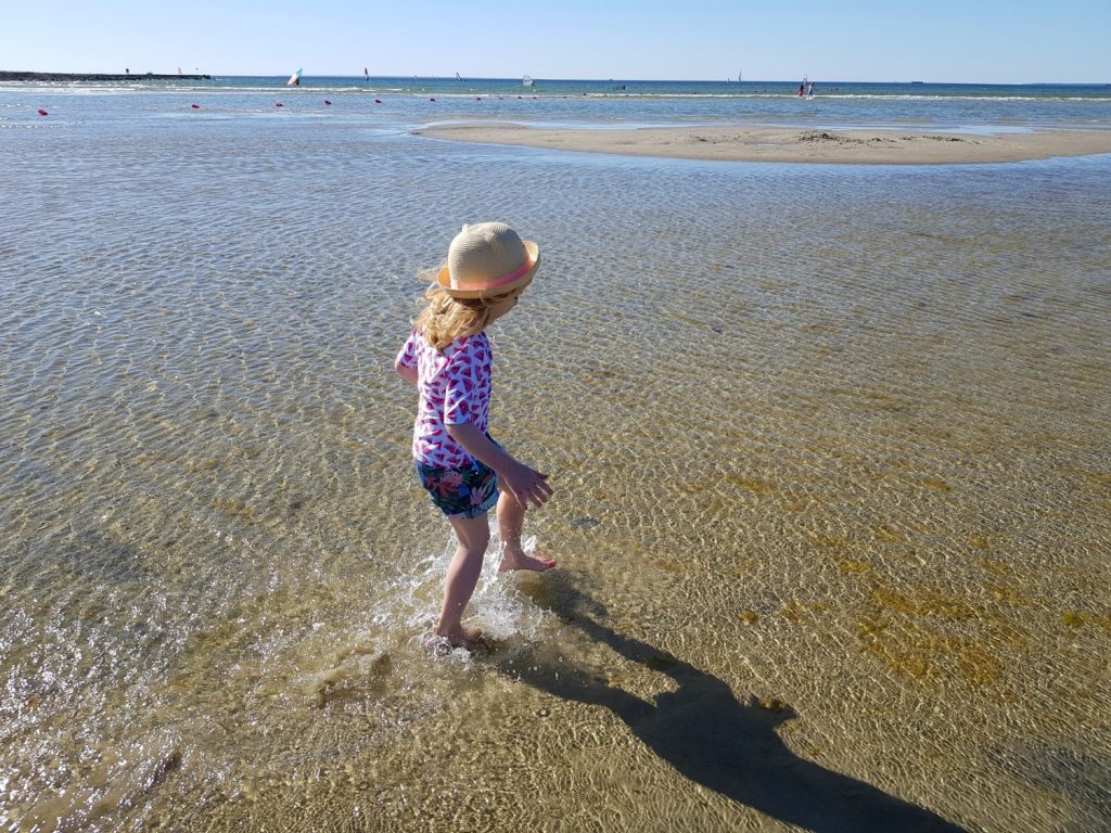 My daughter splashes in the shallows at Pirita - the beach is just one of the many reasons to visit Tallinn, Estonia