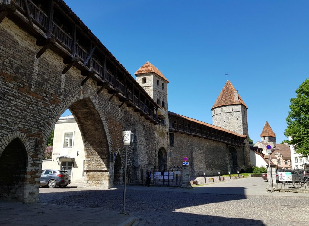 View from the ground to an old gate and two of the old town towers in the medieval walls - the city's history is just one of the many reasons to visit Tallinn, Estonia