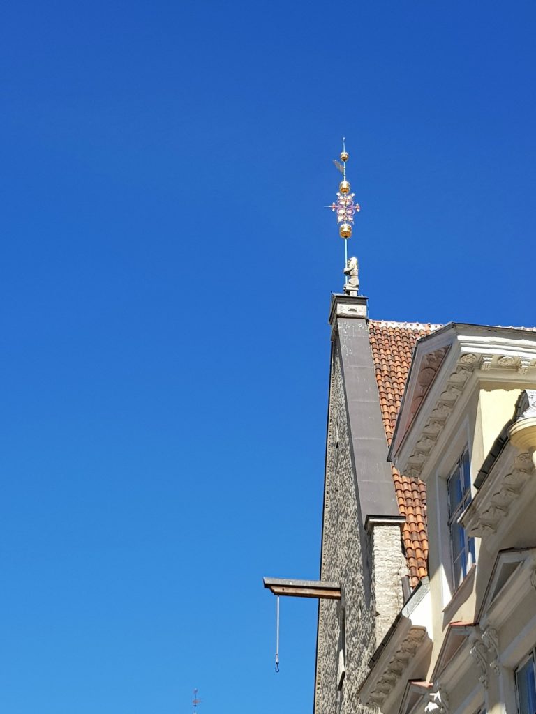 View to a decorative metal adornment on a roof in the Old Town - the city's famously fairytale architecture is just one of the many reasons to visit Tallinn, Estonia