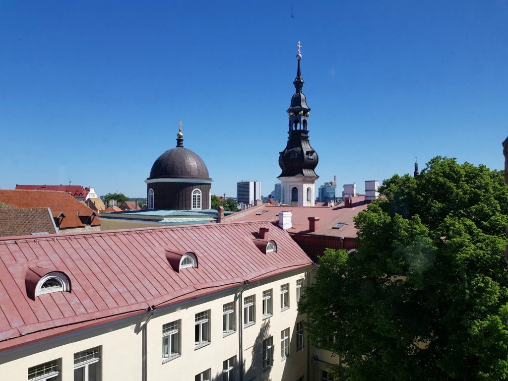 View across rooftops to one of the Old Town's many spires - the city's famously fairytale architecture is just one of the many reasons to visit Tallinn, Estonia