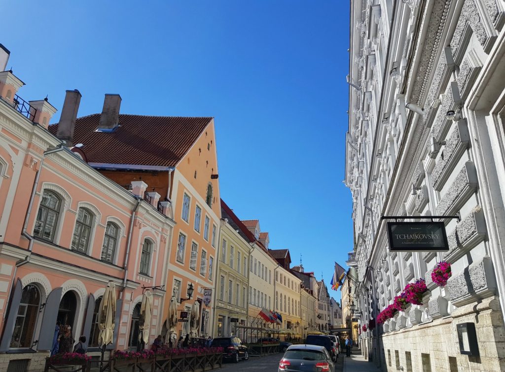 View along pastel pink and colourful buildings on a street in the Old Town - the city's famously fairytale architecture is just one of the many reasons to visit Tallinn, Estonia